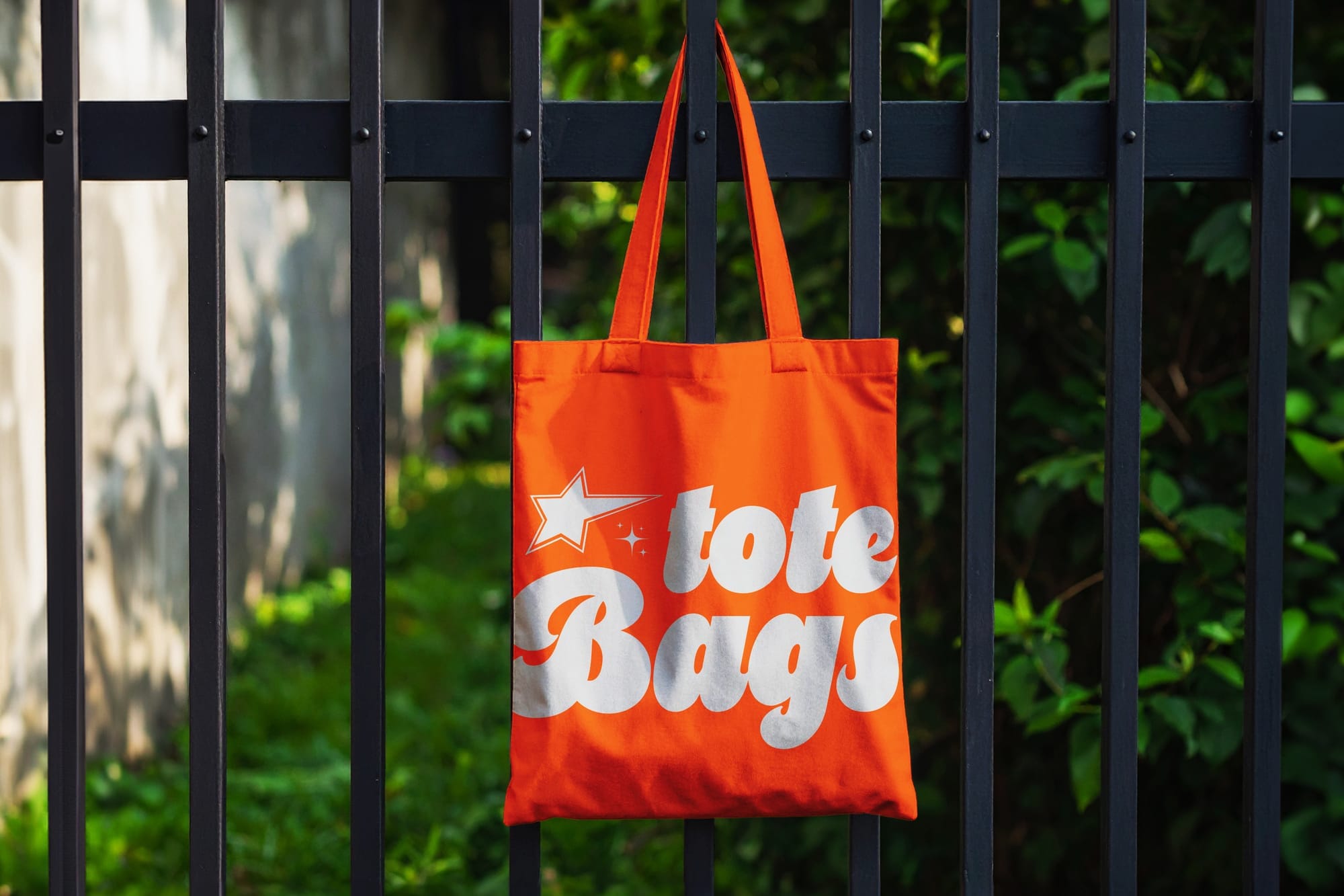 Bright Outdoor Tote Bag Mockup Hanging on Fence