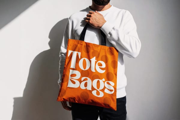 Hand Held Tote Bag Mockup with Sunlight on White Wall